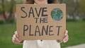 Woman with a poster SAVE THE PLANET. Feasible contribution to the fight against global pollution of nature. Single