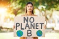 Woman, poster and save planet sign at park for climate change, environment and green eco friendly protest. Young person Royalty Free Stock Photo