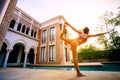 Woman posting warrior yoga pose beside sport water pool