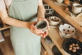 Woman potter in apron holds products in her hands. Royalty Free Stock Photo