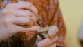 Woman potter making ceramic souvenir penny whistle in pottery workshop