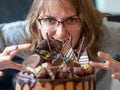 Woman pounces on the cake. Girl wants to eat a beautiful cake. Concept of refusal from the diet in women