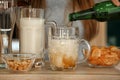 Woman pouring beer into glasses on table in bar Royalty Free Stock Photo