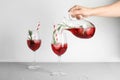 Woman pouring cranberry cocktail into glas Royalty Free Stock Photo