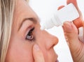 Woman pouring drops in her eyes Royalty Free Stock Photo