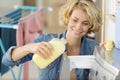 woman pouring fabric conditioner into washing machine drawer