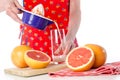 Woman pouring fresh grapefruit juice