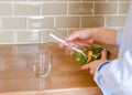 Woman pouring fresh water into a glass from a decanter Royalty Free Stock Photo