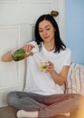 Woman pouring fresh water into a glass from a decanter Royalty Free Stock Photo