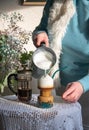 woman pouring frothed milk coffee into morning coffee with tapioca for breakfast