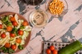 Woman pouring honey mustard dressing into bowl with fresh salad on table Royalty Free Stock Photo