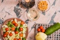 Woman pouring honey mustard dressing into bowl with fresh salad on table Royalty Free Stock Photo