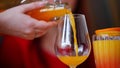 A woman pouring a juice from the bottle in the glass