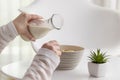 Woman pouring milk into a cereal bowl Royalty Free Stock Photo