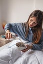 Woman pouring milk into cereal bowl while having breakfast in bed Royalty Free Stock Photo