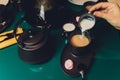 Woman pouring milk in mug of tea from kettle. Royalty Free Stock Photo