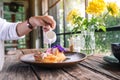 A woman pouring milk into a piece of coconut pie Royalty Free Stock Photo