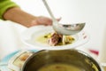 Woman pouring pea soup in a plate Royalty Free Stock Photo
