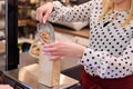 Woman pouring pinto bean to paper paper bag