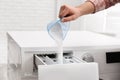 Woman pouring powder into drawer of washing machine, closeup. Laundry day Royalty Free Stock Photo