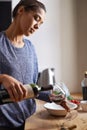 Woman, pouring red wine and home for dinner, relax for peace and leisure with drink in kitchen. Alcohol, glass and Royalty Free Stock Photo