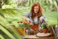 Woman pouring soil into container Royalty Free Stock Photo