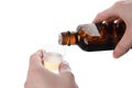 Woman pouring syrup into measuring cup from bottle  on white, closeup. Cough and cold medicine Royalty Free Stock Photo