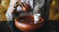 Woman pouring tea into a cup Royalty Free Stock Photo