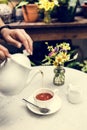 Woman pouring tea in a cup Royalty Free Stock Photo