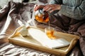 Woman pouring tea in glass mug from teapot. Cozy home hygge style interior