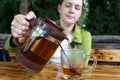 Woman pouring tea into glass Royalty Free Stock Photo