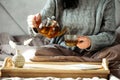 Woman pouring tea in mug from glass teapot. Cozy home hygge style interior. Breakfast still life Royalty Free Stock Photo