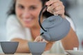 woman pouring tea from teapot Royalty Free Stock Photo