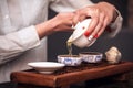 Woman pouring teacup in traditional chinese teaware. Royalty Free Stock Photo