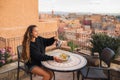 Woman pouring traditional moroccan mint tea on terrace with amazing view Royalty Free Stock Photo