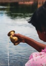 Woman Pouring Water From Brass Faucet