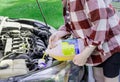 Refilling windshield wiper fluid