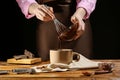 Woman pouring yummy hot chocolate into cup at wooden table, closeup Royalty Free Stock Photo