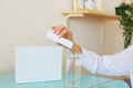 Woman pours the contents of a sachet into a glass. Universal stick pack for products of the food, pharmaceutical