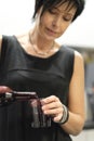 Woman pours into a glass of juice