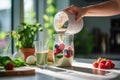 woman pours milk into a glass of berry smoothie with green spinach on the kitchen table, Generative AI