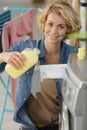 woman pours washing liquid detergent into machine Royalty Free Stock Photo