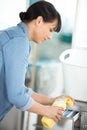 woman pours washing liquid detergent into machine Royalty Free Stock Photo