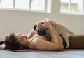 woman practice yoga with dog pug breed enjoy and relax with yoga at home Royalty Free Stock Photo