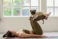 Woman practice yoga with dog pug breed enjoy and relax with yoga at home Royalty Free Stock Photo