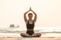 Woman practice yoga lotus pose to meditation with summer vacation on the beach Royalty Free Stock Photo