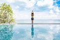 woman practice yoga lotus pose to meditation summer vacation on the pool above the beach,Travel in tropical beach Royalty Free Stock Photo