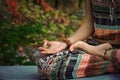 woman practice yoga meditation hands in mudra gesture closeup outdoor autumn day