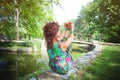 Woman practice yoga outdoor in park by the pond, summer day hea