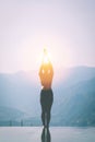 Woman practice yoga on the pool above the Mountain peak Royalty Free Stock Photo